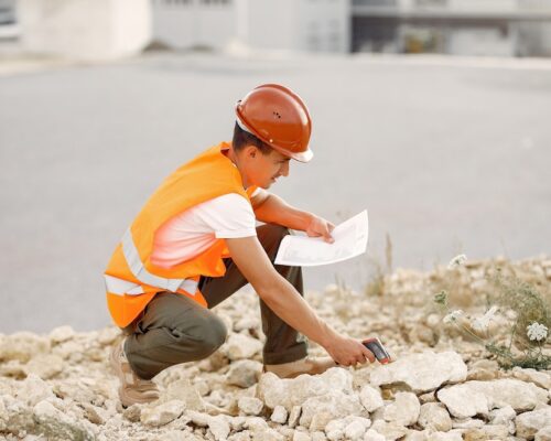 engineer-helmet-standing-by-factory_1157-35548